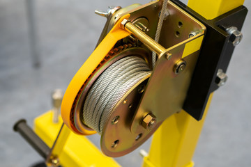 Yellow drum winch. Hand winch. Device for moving load. Rope lever. Power machinery