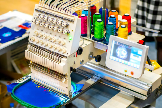 Embroidery Machine. Embroidery machine with computer control. Industrial embroidery equipment. Programmable embroidery machine. Embroidery patterns.