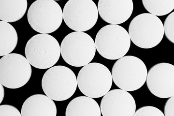White round tablets pills isolated on black background