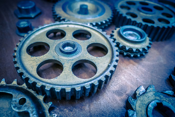 Metal old gears. Blue gears. Many gears of different sizes are on the table.