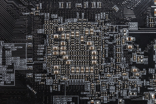 Close-up black PC / Laptop motherboard with electronic circuits and micro chips. Technology background
