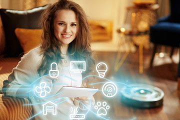 woman using smart home application on tablet PC and robot vacuum