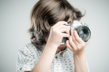 Kid with old photo camera	