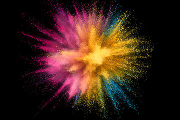 Colored powder explosion. Abstract closeup dust on backdrop. Colorful explode. Paint holi