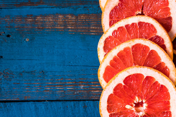 Flat lay slices of raw fresh red orange fruit.