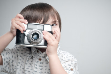 Kid with old photo camera	