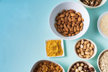 Superfoods in Bowls on blue Background.