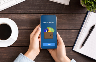Woman holding smartphone with digital wallet application