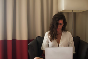 Serious brunette girl woman in checking email while working on freelance via modern laptop computer...