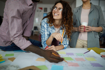 Portrait of creative business team planning project drawing roadmap in office, copy space
