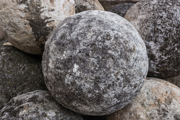 Stone balls on a stone pedestal. The cores are made for throwing a combat catapult. Close up.