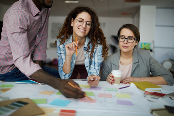 Portrait of contemporary business team planning project drawing roadmap in office, copy space