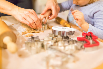 Fototapeta na wymiar Baking with the family - Mother and daughter making self made cookies in a home kitchen