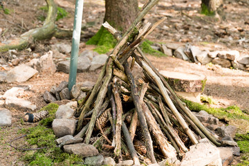 freshly stacked wood in the form of a pyramid for a campfire