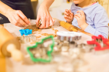 Baking with the family - Mother and daughter making self made cookies in a home kitchen