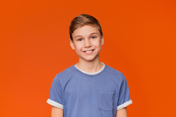 Portrait of young boy on orange background