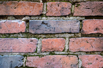 Old brick wall, old texture of red stone blocks closeup.