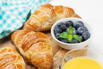 Orange juice and croissants breakfast