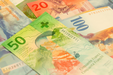 Swiss franc. Background of paper money and coins.