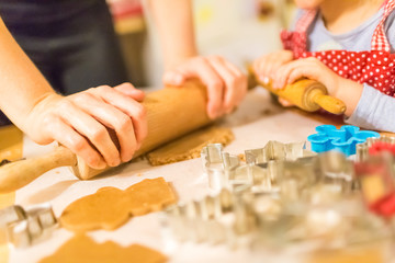 Baking with the family - Mother and daughter making self made cookies in a home kitchen