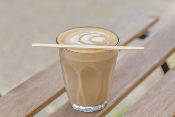 Coffee cup with latte art on a wooden table