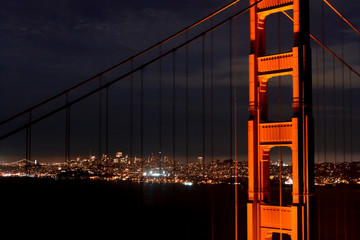 City by the Bay - Glittering San Francisco by night is framed by the Golden Gate Bridge. San Francisco, California, USA