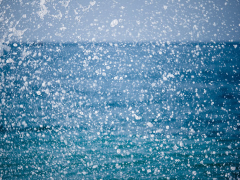Splashes of water against the sea on a sunny summer day © Dmitrii Potashkin