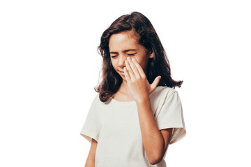 Sinus pain, sinus pressure, sinusitis. Sad child holding her nose and head because sinus pain