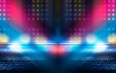Dark empty stage, multicolored rays of neon searchlight, wet asphalt, smoke, night shooting, bokeh...