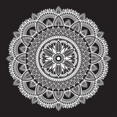 White round ethnic mandala on black background. Circular decorative pattern.