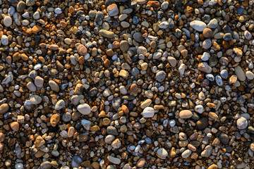 Pebbles mixed with sand of the beautiful Skala beach, Kefalonia island, Ionian sea, Greece.