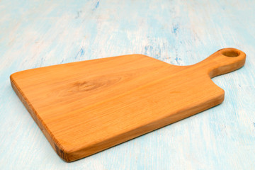 Wooden oak cutting board. Kitchenware. Copy space.