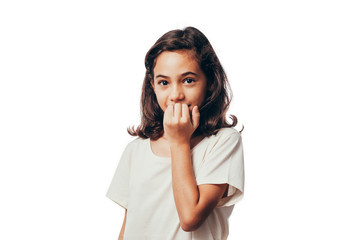 Fototapeta premium Portrait of young girl biting her nails on white background