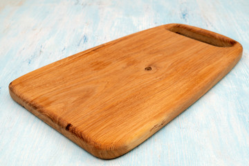 Wooden oak cutting board. Kitchenware. Copy space.