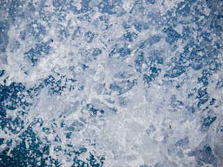 Splashes of water against the sea on a sunny summer day