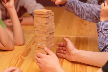 Children play a board game, a wooden tower