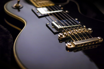 Fototapeta na wymiar electric guitar closeup on dark background