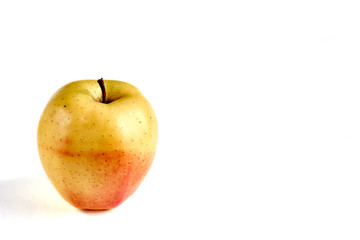 Apple yellow with red side on a white background with a place for an inscription