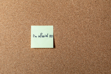 green sticker on brown table. color sticker, motivational, quote and words, note, message