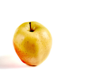 Apple yellow with red side on a white background with a place for an inscription