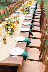 Table settings for a luxury wedding reception. Outdoor wedding