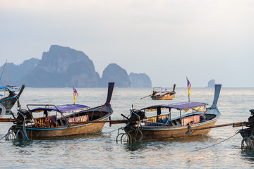 Ao Nang, Krabi Province, Thailand - January 12, 2019: Several moored thai traditional long-tail...