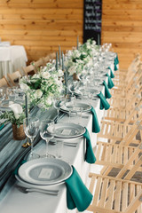 Table settings for a luxury wedding reception. Outdoor wedding
