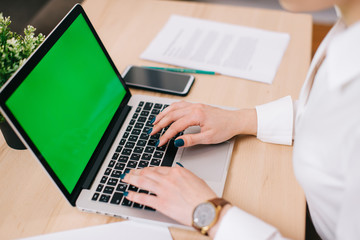 Close up of female hands typing text on laptop keyboard