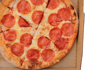 Pepperoni pizza slices in delivery box close up top view. Traditional hot italian recipe pizza with pepperoni sausage, cheese and tomato sauce. Pizza in card paper box isolated on white background