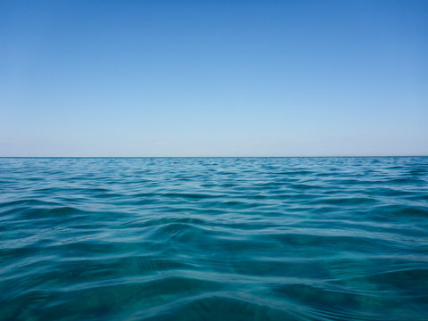 Pure nature of turquoise sea water and blue clear sky of beautiful Skala beach of Kefalonia island, Ionian sea, Greece.