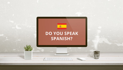Concept of Spanish language learning online. Question Do you speak Spanish on a computer display on work desk.