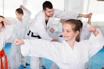 Children trying martial moves in karate class © JackF