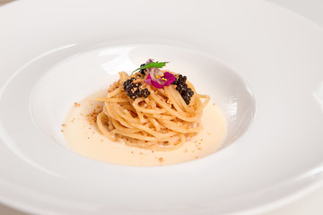 Italian pasta with black caviar and cream