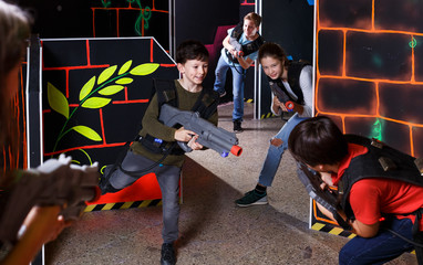 Kids playing laser tag on labyrinth